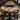 Dining area with tables, chairs, and people in a restaurant setting.