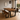 Dining area with handmade wooden table and bench in a dark oak colour in a modern interior setting.